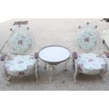 A pair of fin-de-siecle cast iron garden chairs, with wrought iron roses, the frame painted cream