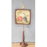 A Victorian mahogany and brass pole fire screen, the tapestry panel depicting a young boy and his