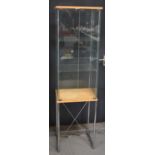A modern glass display cabinet on a chrome style stand.