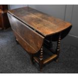 A 18th century oak drop leaf table with turned legs and gates raising the two demi lune leaves. 76cm