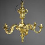 A Neoclassical style brass six branch chandelier with scrolling arms.