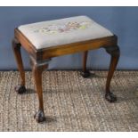 A Georgian stool with tapestry upholstered seat, cabriole legs with ball and claw feet, 49cm high by