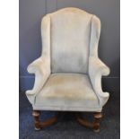 A 19th century wingback armchair, with walnut turned base.