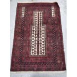 A Middle Eastern prayer rug, with red ground and having bands of stylised inner borders, 137 by