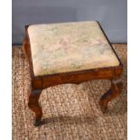 An 18th century burr yew wood veneered French stool with petit point needlework upholstered drop