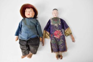 A Chinese doll, dressed traditionally as a courtier, with embroidered linen robe, the yoke and