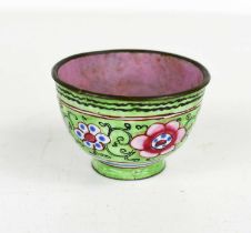 A small Chinese cloisonne bowl, with pink interior, the outside having green ground with flowers,