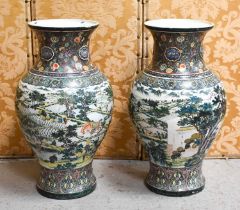A large and impressive pair of Chinese floor vases, enamelled to depict figures working in the