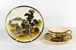 A Qing Dynasty Chinese trio; cup, saucer and cake plate, decorated with figures in landscape, and