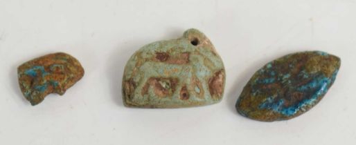 Three ancient Egyptian faience amulets one in the form of an animal, 1.75cm by 1.5cm.