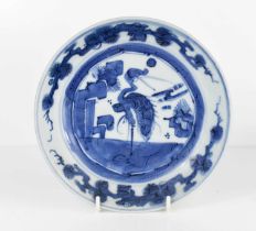 A 19th century Qing period Chinese blue and white dish depicting a crane, signed to the base, 19cm