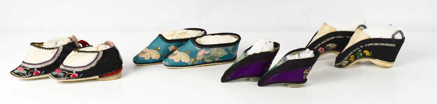 Four pairs of Chinese 19th century Qing Dynasty hand embroidered lotus shoes, of various regional