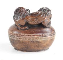 A Chinese soapstone box and cover of oval form the top carved with two dogs of Fo, and a flaming