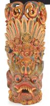 A Balinese polychrome and gilt wood mythical beast wall hanging, 54cm.