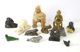 A John Koonook Inuit stone sculpture of a hunter together with various stone carvings to include a