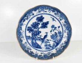 A Chinese blue and white dish, possibly of the Nankin Cargo, with rust coloured wavy edge, depicting