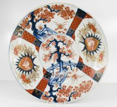 A Chinese Qing Dynasty Imari charger, with central circular section painted with a phoenix in a