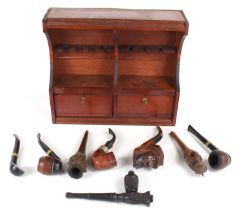 A pine smokers cabinet together with a group of smoking pipes to include French Saint-Claude