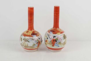A pair of Japanese Satsuma ware bottle vases, decorated with figures amongst landscapes, with fans