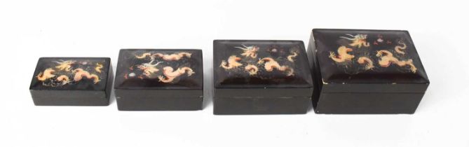A set of four lacquered Chinese boxes, with dragon decoration.