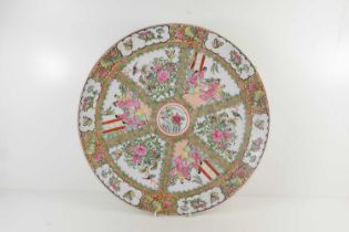 A Canton Famille Rose charger, decorated throughout with reserves depicting interior scenes