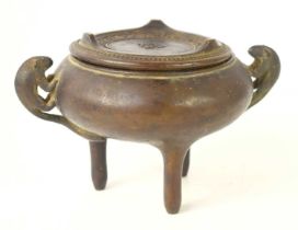 An early Chinese bronze censor and cover / stand, the twin handles in the form of animals and raised