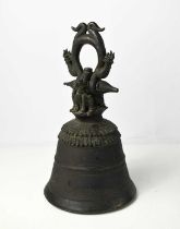 A Tibetan bronze bell, cast with two dragons to the top and hoop handle, 36cm high.