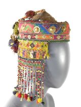 A 19th century embroidered and beaded hat, likely Anatolian, with applied chain and shields, with