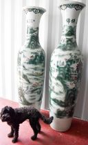 A pair of large Chinese Soldier vases, depicting cranes amidst foliage, standing 2 metres high.