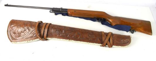 A .22 air rifle with leather pouch.