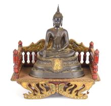 A Tibetan bronze figure of Buddha Vajraasanna on a double lotus base, his right hand lowered in