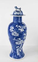 An early 20th century Chinese blue and white baluster jar and cover, the body depicting prunus
