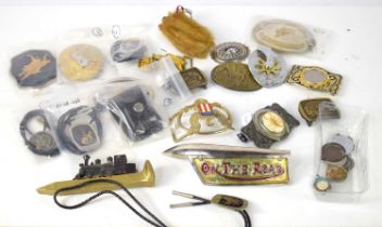 A group of collectables to include USA related belt buckles, German silver pendants on woven