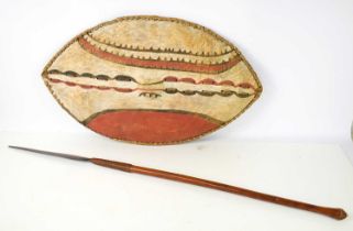 An African tribal spear and Maasai animal hide shield An African Maasai animal hide shield, wooden