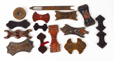 A selection of 19th century treen silk winders, many red lacquered, of differing style; one