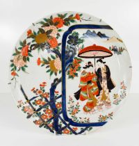 A Japanese charger, likely Edo period, decorated in the Imari palette, with off-set couple holding a