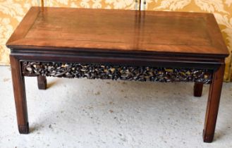 A Chinese hardwood carved low table, with pierced and carved decorative rails, united with chamfered