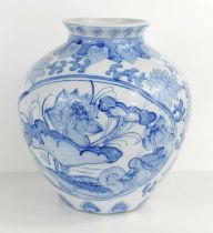 A large Chinese blue and white vase of ovoid form painted with ducks within on a moulded ground,