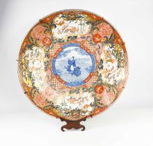 A very large early 19th century Japanese Imari charger, the central blue and white roundel decorated