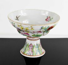 A Chinese Canton Famille Rose pedestal bowl, decorated with chrysanthemums and blossom, above a