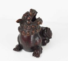 An early bronze dog of fo, with red patination, with impressed calligraphy mark to the underside,