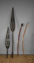 A collection of various tribal items to include a shell and hide covered bow, two African carved