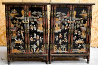 A pair of Chinese two door cabinets, with hocks and a shelf, the concave shape decorated with