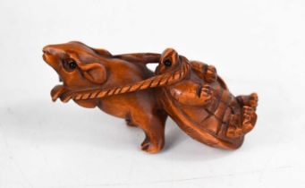 A boxwood netsuke of a rat and a tortoise, both with glass eyes, 6.5cm long.