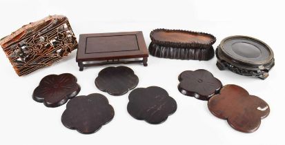 A group of Chinese treen: six 19th century drink coasters, three hardwood carved stands of various
