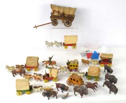 A group of vintage diecast covered wagons and stagecoaches with horses, possibly made by