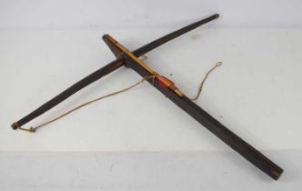 An antique wooden crossbow, the bow having a wooden trigger, possibly tribal, 65cm by 76cm.