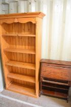 A pine floor standing bookcase, 197cm high, together with a small oak bureau