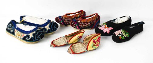 A group of four Chinese pairs of shoes, all hand embroidered in vibrant colours, circa 1900, to