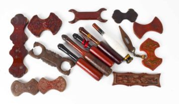 A selection of 19th century treen silk winders, mostly red lacquered, of differing style, together